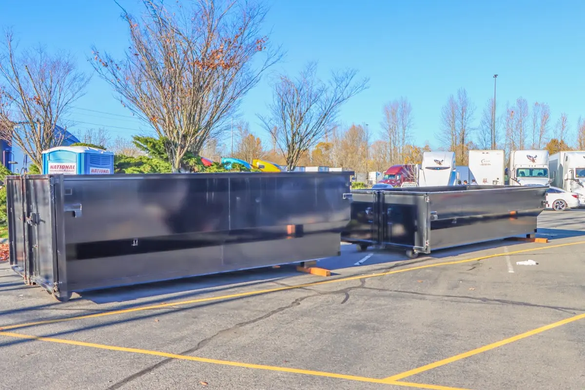 Professional dumpster rental service with roll-off container on residential driveway in Beatrice